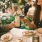 a couple of people sit at a table with food and drinks