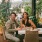 a man and woman sitting at a table with food